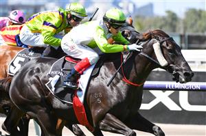 MELBOURNE, AUSTRALIA - MARCH 19: Craig Williams riding Blandford Lad winning Race 1, the Kennedy Grand Handicap Classic, during All-Star Mile Race day at Flemington Racecourse on March 19, 2022 in Melbourne, Australia. (Photo by Vince Caligiuri/Getty Images)