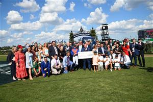 MELBOURNE, AUSTRALIA - MARCH 19: Jamie Kah poses with connections and owner Ambassador winner Nicholas Bouseka holding cheque after Zaaki wonRace 6, the The Seppelt Wines All-star Mile, during All-Star Mile Race day at Flemington Racecourse on March 19, 2022 in Melbourne, Australia. (Photo by Vince Caligiuri/Getty Images)