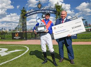 MELBOURNE, AUSTRALIA - MARCH 19: Jamie Kah poses with owner Ambassador winner Nicholas Bouseka holding cheque after Zaaki wonRace 6, the The Seppelt Wines All-star Mile, during All-Star Mile Race day at Flemington Racecourse on March 19, 2022 in Melbourne, Australia. (Photo by Vince Caligiuri/Getty Images)