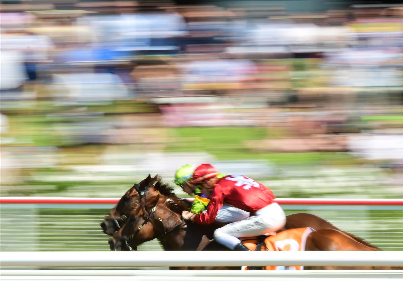 MELBOURNE, AUSTRALIA - MARCH 26:  Michael Dee riding Forever Free (green) defeats Logan McNeil riding Midwest in Race 3, the Ids Security Handicap, during Mornington Cup Day at Mornington Racecourse on March 26, 2022 in Melbourne, Australia. (Photo by Vince Caligiuri/Getty Images)