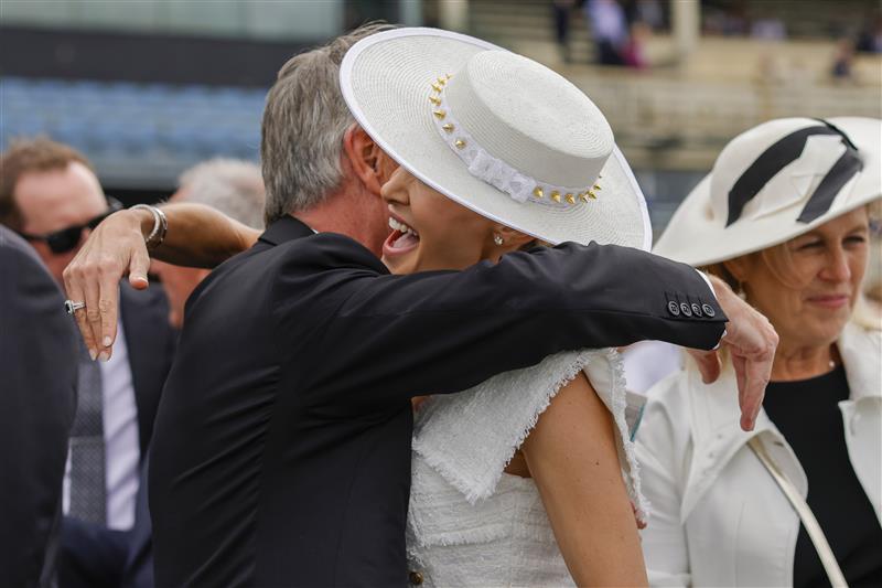 SYDNEY, AUSTRALIA - APRIL 02: Clare Hawkes, wife of trainer Michael Hawkes is congratulated by winning connections during The Star Championships Day 1 at Royal Randwick Racecourse on April 02, 2022 in Sydney, Australia. The Championships race days are the highlight of the Sydney Autumn Racing Carnival. The Championships Day 1 features four Group 1 events headlined by the $3 million Doncaster Mile and $2 million Australian Derby. (Photo by Jenny Evans/Getty Images)