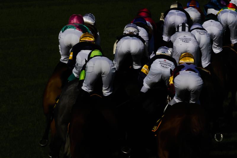 SYDNEY, AUSTRALIA - APRIL 09: The rear view of horses and jockeys rounding the first circut of race 7 the Schweppes Sydney Cup during The Championships Day 2, Longines Queen Elizabeth Stakes Day, at Royal Randwick Racecourse on April 09, 2022 in Sydney, Australia. (Photo by Jenny Evans/Getty Images)