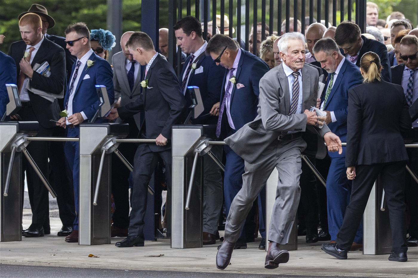 SYDNEY, AUSTRALIA - APRIL 09: People race through the turnstiles as they open ahead of of The Championships Day 2, Longines Queen Elizabeth Stakes Day at Royal Randwick Racecourse on April 09, 2022 in Sydney, Australia. The Championships race days are the highlight of the Sydney Autumn Racing Carnival. (Photo by Jenny Evans/Getty Images)