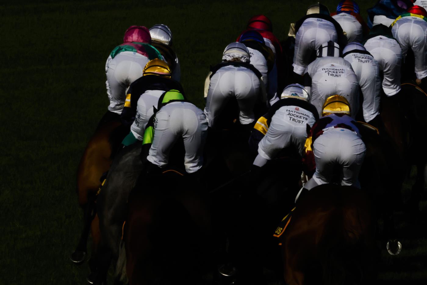 SYDNEY, AUSTRALIA - APRIL 09: The rear view of horses and jockeys rounding the first circut of race 7 the Schweppes Sydney Cup during The Championships Day 2, Longines Queen Elizabeth Stakes Day, at Royal Randwick Racecourse on April 09, 2022 in Sydney, Australia. (Photo by Jenny Evans/Getty Images)