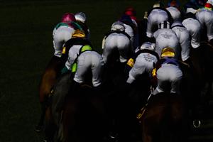 SYDNEY, AUSTRALIA - APRIL 09: The rear view of horses and jockeys rounding the first circut of race 7 the Schweppes Sydney Cup during The Championships Day 2, Longines Queen Elizabeth Stakes Day, at Royal Randwick Racecourse on April 09, 2022 in Sydney, Australia. (Photo by Jenny Evans/Getty Images)