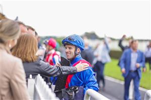 HAWKESBURY, AUSTRALIA - APRIL 30: A winning connection pats the shoulder of Tommy Berry after winning race 5 the Living Turf Bm78 Handicap on Sacrimony during Hawkesbury Cup Day at Hawkesbury Race Club on April 30, 2022 in Hawkesbury, Australia. (Photo by Jenny Evans/Getty Images)