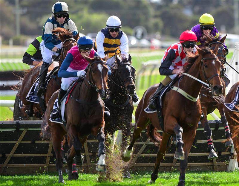 WARRNAMBOOL, AUSTRALIA - MAY 03: Aaron Kuru riding Rider In The Snow (ctr white cap) winning Race 3, the George Taylor Memorial Maiden Hurdle, during Brierly Steeplechase day at Warrnambool Racing Club on May 03, 2022 in Warrnambool, Australia. (Photo by Vince Caligiuri/Getty Images)