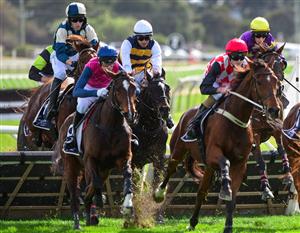 WARRNAMBOOL, AUSTRALIA - MAY 03: Aaron Kuru riding Rider In The Snow (ctr white cap) winning Race 3, the George Taylor Memorial Maiden Hurdle, during Brierly Steeplechase day at Warrnambool Racing Club on May 03, 2022 in Warrnambool, Australia. (Photo by Vince Caligiuri/Getty Images)