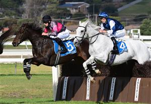 WARRNAMBOOL, AUSTRALIA - MAY 03: Will Gordon riding Vanguard jumps diring the first lap alongside Aaron Mitchell riding Valac before winning Race 6, the 3yb Fm Brierly Steeplechase, during Brierly Steeplechase day at Warrnambool Racing Club on May 03, 2022 in Warrnambool, Australia. (Photo by Vince Caligiuri/Getty Images)
