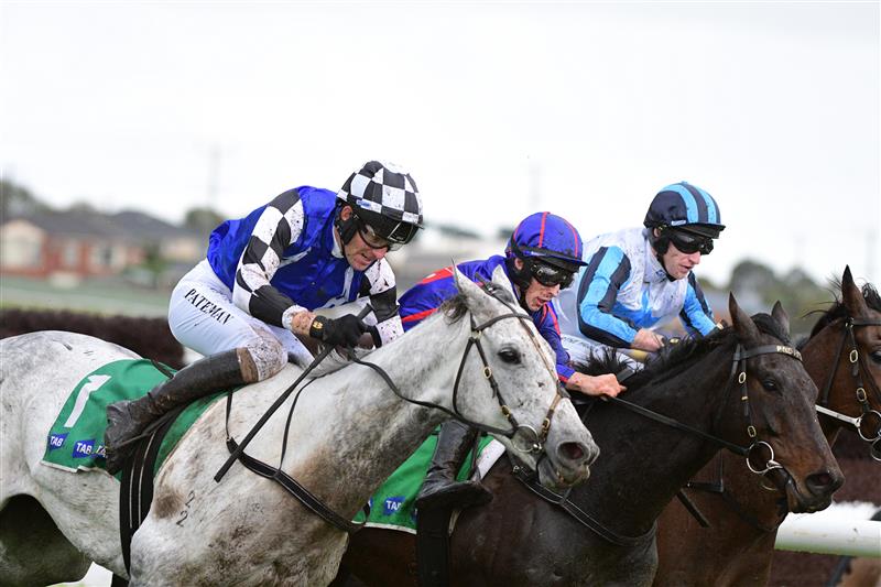 WARRNAMBOOL, AUSTRALIA - MAY 04: Steven Pateman riding Saunter Boy races to win from Will Gordon riding St Arnicca and Lee Horner riding Out and Dreaming (r) before winning Race 6, the Sovereign Resort Galleywood Hurdle, during Galleywood Hurdle day at Warrnambool Racing Club on May 04, 2022 in Warrnambool, Australia. (Photo by Vince Caligiuri/Getty Images)