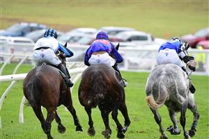 WARRNAMBOOL, AUSTRALIA - MAY 04: Steven Pateman riding Saunter Boy (r) races to win from Will Gordon riding St Arnicca and Lee Horner riding Out and Dreaming (L) before winning Race 6, the Sovereign Resort Galleywood Hurdle, during Galleywood Hurdle day at Warrnambool Racing Club on May 04, 2022 in Warrnambool, Australia. (Photo by Vince Caligiuri/Getty Images)