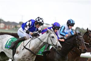 WARRNAMBOOL, AUSTRALIA - MAY 04: Steven Pateman riding Saunter Boy races to win from Will Gordon riding St Arnicca and Lee Horner riding Out and Dreaming (r) before winning Race 6, the Sovereign Resort Galleywood Hurdle, during Galleywood Hurdle day at Warrnambool Racing Club on May 04, 2022 in Warrnambool, Australia. (Photo by Vince Caligiuri/Getty Images)