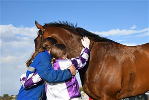 WARRNAMBOOL, AUSTRALIA - MAY 04: Madison Lloyd hugs Frankie Pinot after winning Race 8, the The Midfield Group Wangoom Handicap, during Galleywood Hurdle day at Warrnambool Racing Club on May 04, 2022 in Warrnambool, Australia. (Photo by Vince Caligiuri/Getty Images)