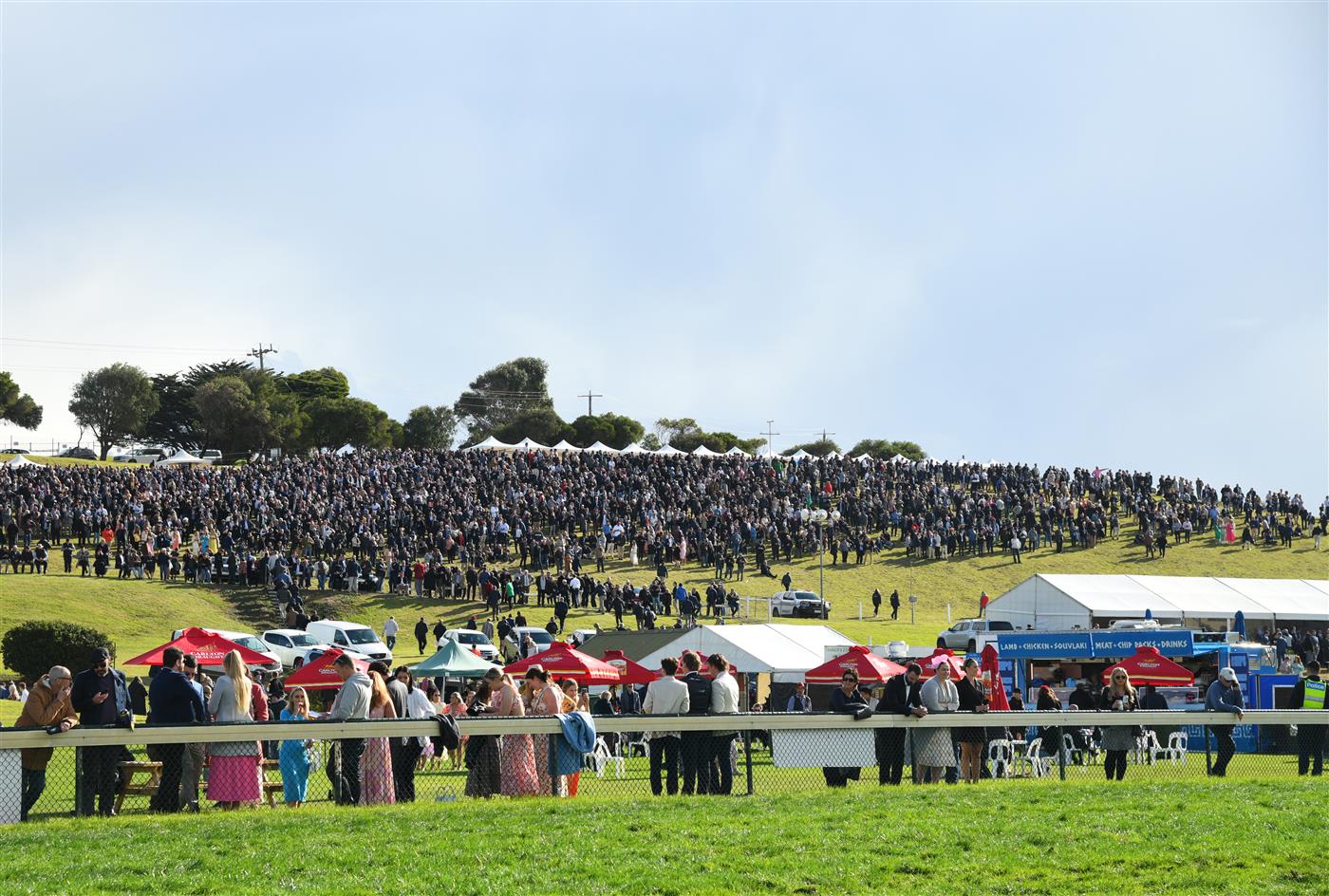 WARRNAMBOOL, AUSTRALIA - MAY 05:  General view of huge crowd on the hill before Race 7, the Lyndoch Living Grand Annual Steeplechase, during Grand Annual day at Warrnambool Racing Club on May 05, 2022 in Warrnambool, Australia. (Photo by Vince Caligiuri/Getty Images)