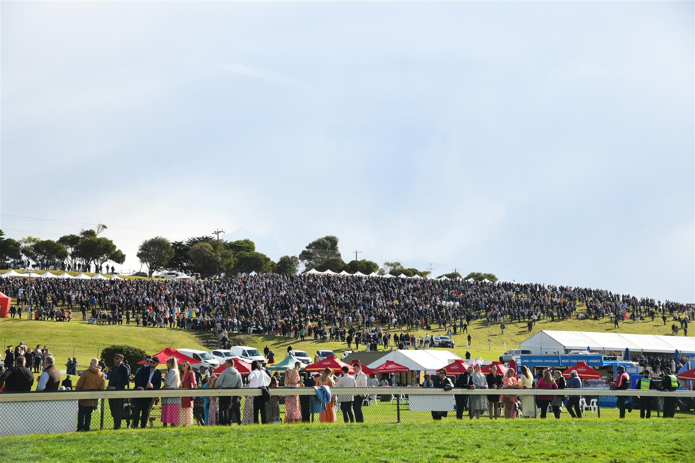 WARRNAMBOOL, AUSTRALIA - MAY 05:  General view of huge crowd on the hill before Race 7, the Lyndoch Living Grand Annual Steeplechase, during Grand Annual day at Warrnambool Racing Club on May 05, 2022 in Warrnambool, Australia. (Photo by Vince Caligiuri/Getty Images)