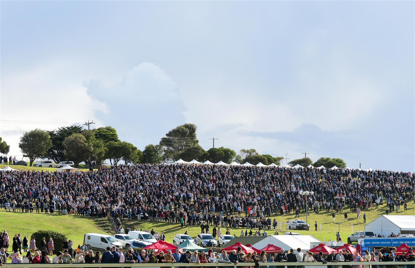 WARRNAMBOOL, AUSTRALIA - MAY 05:  General view of huge crowd on the hill before Race 7, the Lyndoch Living Grand Annual Steeplechase, during Grand Annual day at Warrnambool Racing Club on May 05, 2022 in Warrnambool, Australia. (Photo by Vince Caligiuri/Getty Images)