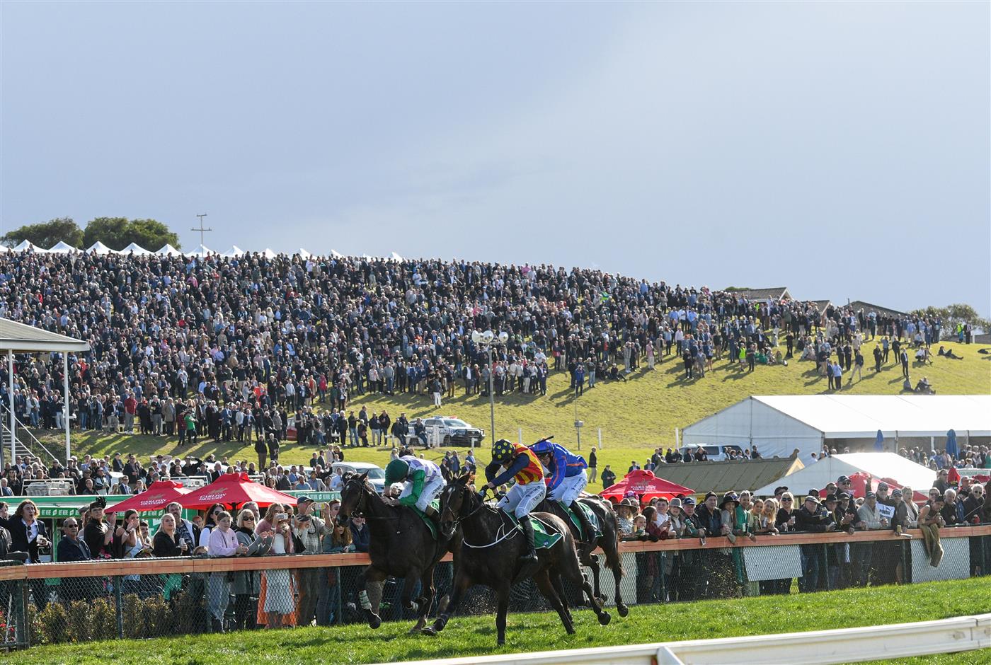 WARRNAMBOOL, AUSTRALIA - MAY 05:  William McCarthy riding Heberite (ctr) defeating Police Camp and Eyes are Blue in Race 7, the Lyndoch Living Grand Annual Steeplechase, during Grand Annual day at Warrnambool Racing Club on May 05, 2022 in Warrnambool, Australia. (Photo by Vince Caligiuri/Getty Images)