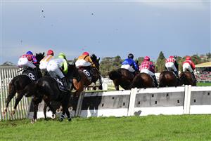 WARRNAMBOOL, AUSTRALIA - MAY 05: Darryl Horner (Jnr) riding El Diez (yellow red cap) jumps before Race 1, the Hammonds Paints Champion Novice Hurdle, during Grand Annual day at Warrnambool Racing Club on May 05, 2022 in Warrnambool, Australia. (Photo by Vince Caligiuri/Getty Images)