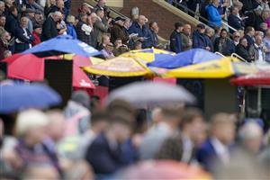 YORK, ENGLAND - MAY 11: Racegoers and bookmakers umbrellas at York Racecourse on May 11, 2022 in York, England. (Photo by Alan Crowhurst/Getty Images)