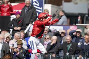 YORK, ENGLAND - MAY 11: Frankie Dettori leaps from Emily Upjohn in the winners enclosure after victory in The Tattersalls Musidora Stakes at York Racecourse on May 11, 2022 in York, England. (Photo by Alan Crowhurst/Getty Images)
