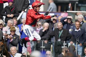 YORK, ENGLAND - MAY 11: Frankie Dettori leaps from Emily Upjohn in the winners enclosure after victory in The Tattersalls Musidora Stakes at York Racecourse on May 11, 2022 in York, England. (Photo by Alan Crowhurst/Getty Images)