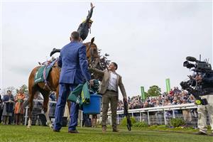 YORK, ENGLAND - MAY 13: Frankie Dettori and the flying dismount after riding Stradivarius to victory in The Paddy Power Yorkshire Cup Stakes at York Racecourse on May 13, 2022 in York, England. (Photo by Alan Crowhurst/Getty Images)