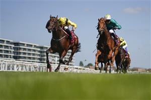 NEWBURY, ENGLAND - MAY 14: Tom Marquand riding Ilaraab (yellow) win The Al Rayyan Stakes at Newbury Racecourse on May 14, 2022 in Newbury, England. (Photo by Alan Crowhurst/Getty Images)