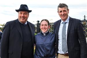MELBOURNE, AUSTRALIA - MAY 14: Alana Kelly poses with Nick Williams and trainer Robert Hickmott after riding Point Nepean to win Race 7, the Lexus Andrew Ramsden, during Melbourne Racing at Flemington Racecourse on May 14, 2022 in Melbourne, Australia. (Photo by Vince Caligiuri/Getty Images)