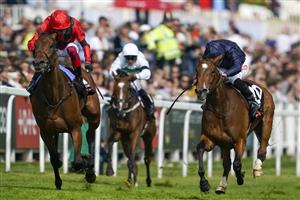 EPSOM, ENGLAND - JUNE 03: Ryan Moore riding Tuesday (R, blue) win The Cazoo Oaks from Frankie Dettori and Emily Upjohn (L, red) during Ladies Day at Epsom Racecourse on June 03, 2022 in Epsom, England. (Photo by Alan Crowhurst/Getty Images)