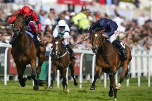 EPSOM, ENGLAND - JUNE 03: Ryan Moore riding Tuesday (R, blue) win The Cazoo Oaks from Frankie Dettori and Emily Upjohn (L, red) during Ladies Day at Epsom Racecourse on June 03, 2022 in Epsom, England. (Photo by Alan Crowhurst/Getty Images)