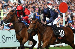 EPSOM, ENGLAND - JUNE 03: Ryan Moore riding Tuesday (R blue) wins The Cazoo Oaks from Frankie Dettori and Emily Up John (L, red) during Ladies Day at Epsom Racecourse on June 03, 2022 in Epsom, England. (Photo by Andrew Redington/Getty Images)