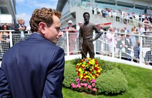 EPSOM, ENGLAND - JUNE 03: Jockey Ryan Moore looks on after laying a wreath at the base of the Lester Piggott statue following Piggott's recent passing during Ladies Day at Epsom Racecourse on June 03, 2022 in Epsom, England. (Photo by Andrew Redington/Getty Images)