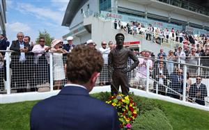 EPSOM, ENGLAND - JUNE 03: Jockey Ryan Moore looks on after laying a wreath at the base of the Lester Piggott statue following Piggott's recent passing during Ladies Day at Epsom Racecourse on June 03, 2022 in Epsom, England. (Photo by Andrew Redington/Getty Images)