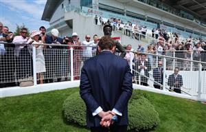 EPSOM, ENGLAND - JUNE 03: Jockey Ryan Moore lays a wreath at the base of the Lester Piggott statue following Piggott's recent passing during Ladies Day at Epsom Racecourse on June 03, 2022 in Epsom, England. (Photo by Andrew Redington/Getty Images)