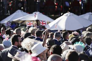 ASCOT, ENGLAND - JUNE 14: Racegoers wave Union Jack flags during the sing-along at the end of the first day of Royal Ascot 2022 at Ascot Racecourse on June 14, 2022 in Ascot, England. (Photo by John Phillips/Getty Images for Ascot Racecourse)