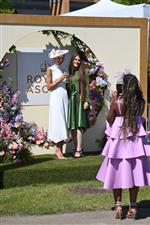 ASCOT, ENGLAND - JUNE 14: Racegoers photographed in front of signage during Royal Ascot 2022 at Ascot Racecourse on June 14, 2022 in Ascot, England. (Photo by Eamonn M. McCormack/Getty Images for Ascot Racecourse)