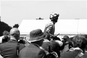 ASCOT, ENGLAND - JUNE 14: (EDITORS NOTE: This image has been converted to black and white.) A general view of a Jockey during Royal Ascot 2022 at Ascot Racecourse on June 14, 2022 in Ascot, England. (Photo by Eamonn M. McCormack/Getty Images for Ascot Racecourse)
