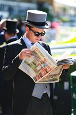ASCOT, ENGLAND - JUNE 14: A racegoer reads during Royal Ascot 2022 at Ascot Racecourse on June 14, 2022 in Ascot, England. (Photo by Eamonn M. McCormack/Getty Images for Ascot Racecourse)