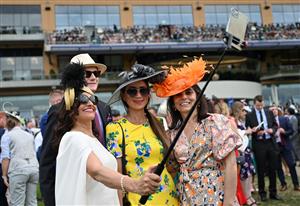 Race-goers takes a selfie photograph as they attend the second day of the Royal Ascot horse racing meet, in Ascot, west of London on June 15, 2022. (Photo by JUSTIN TALLIS / AFP) (Photo by JUSTIN TALLIS/AFP via Getty Images)