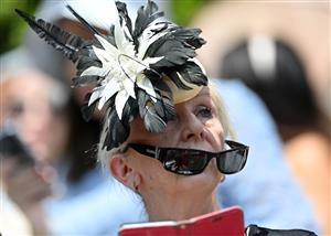A racegoer attends the second day of the Royal Ascot horse racing meet, in Ascot, west of London on June 15, 2022. (Photo by JUSTIN TALLIS / AFP) (Photo by JUSTIN TALLIS/AFP via Getty Images)
