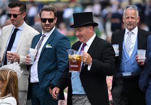 A racegoer carries a jug of Pimms as he attends the second day of the Royal Ascot horse racing meet, in Ascot, west of London on June 15, 2022. (Photo by JUSTIN TALLIS / AFP) (Photo by JUSTIN TALLIS/AFP via Getty Images)
