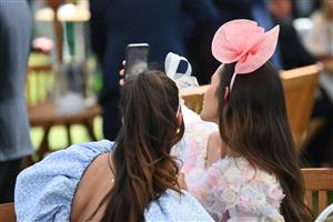 ASCOT, ENGLAND - JUNE 15: Racegoers take a selfie together during Royal Ascot 2022 at Ascot Racecourse on June 15, 2022 in Ascot, England. (Photo by Eamonn M. McCormack/Getty Images for Ascot Racecourse)