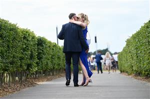 ASCOT, ENGLAND - JUNE 15: Racegoers kiss during Royal Ascot 2022 at Ascot Racecourse on June 15, 2022 in Ascot, England. (Photo by Eamonn M. McCormack/Getty Images for Ascot Racecourse)