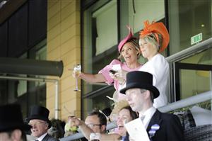 ASCOT, ENGLAND - JUNE 15: Racegoers watch a race from inside the Royal Enclosure during Royal Ascot 2022 at Ascot Racecourse on June 15, 2022 in Ascot, England. (Photo by John Phillips/Getty Images for Ascot Racecourse)