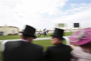 ASCOT, ENGLAND - JUNE 15: Racegoers watch a race from inside the Royal Enclosure during Royal Ascot 2022 at Ascot Racecourse on June 15, 2022 in Ascot, England. (Photo by John Phillips/Getty Images for Ascot Racecourse)
