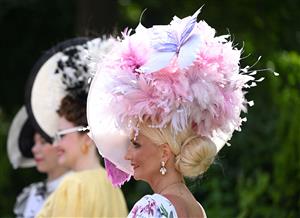 Race-goers arrive to attend the third day, known as the Lady