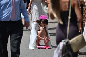 A race-goer arranges her high heels during the third day, known as the Lady