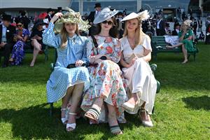 Racegoers enjoy the summer sunshine on the third day, known as the Lady