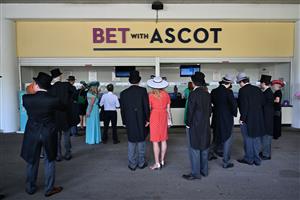Racegoers queue to place a bet on the third day, known as the Lady