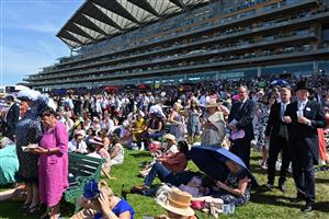 Racegoers enjoy the summer sunshine on the third day, known as the Lady
